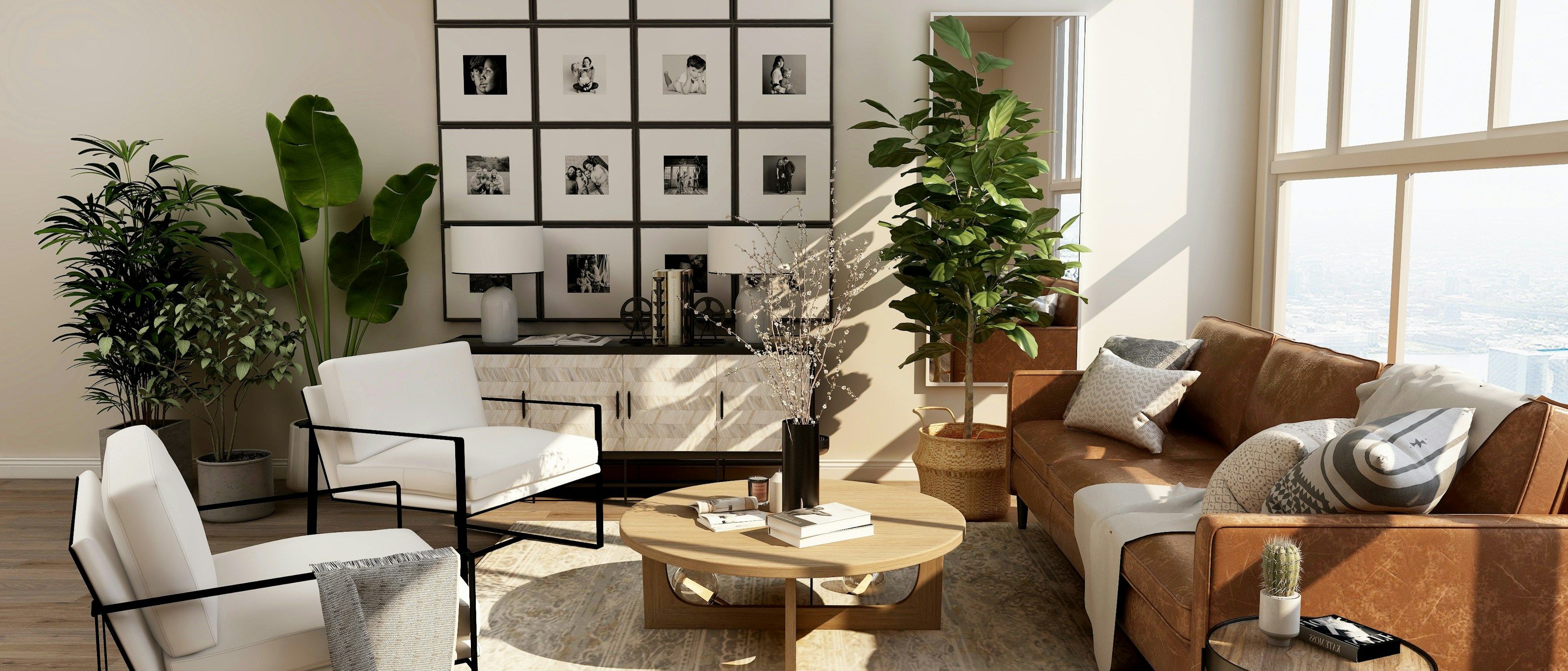 Two cream bouclé armchairs and a tan leather sofa around a low oak coffee table, with a gallery wall of framed prints behind