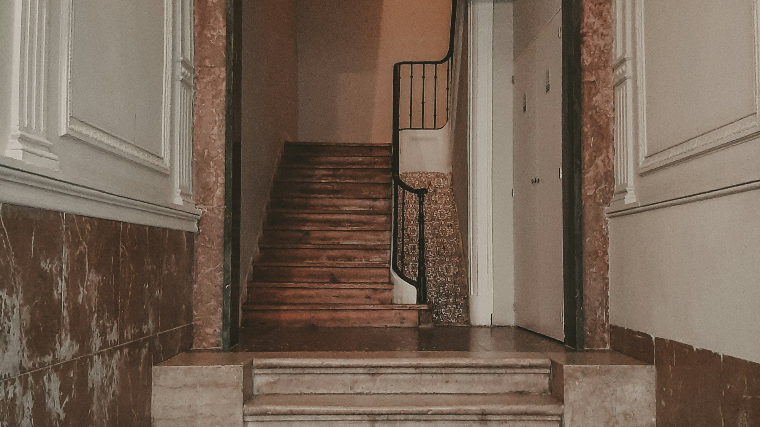 A stone staircase leading up from the entrance hall