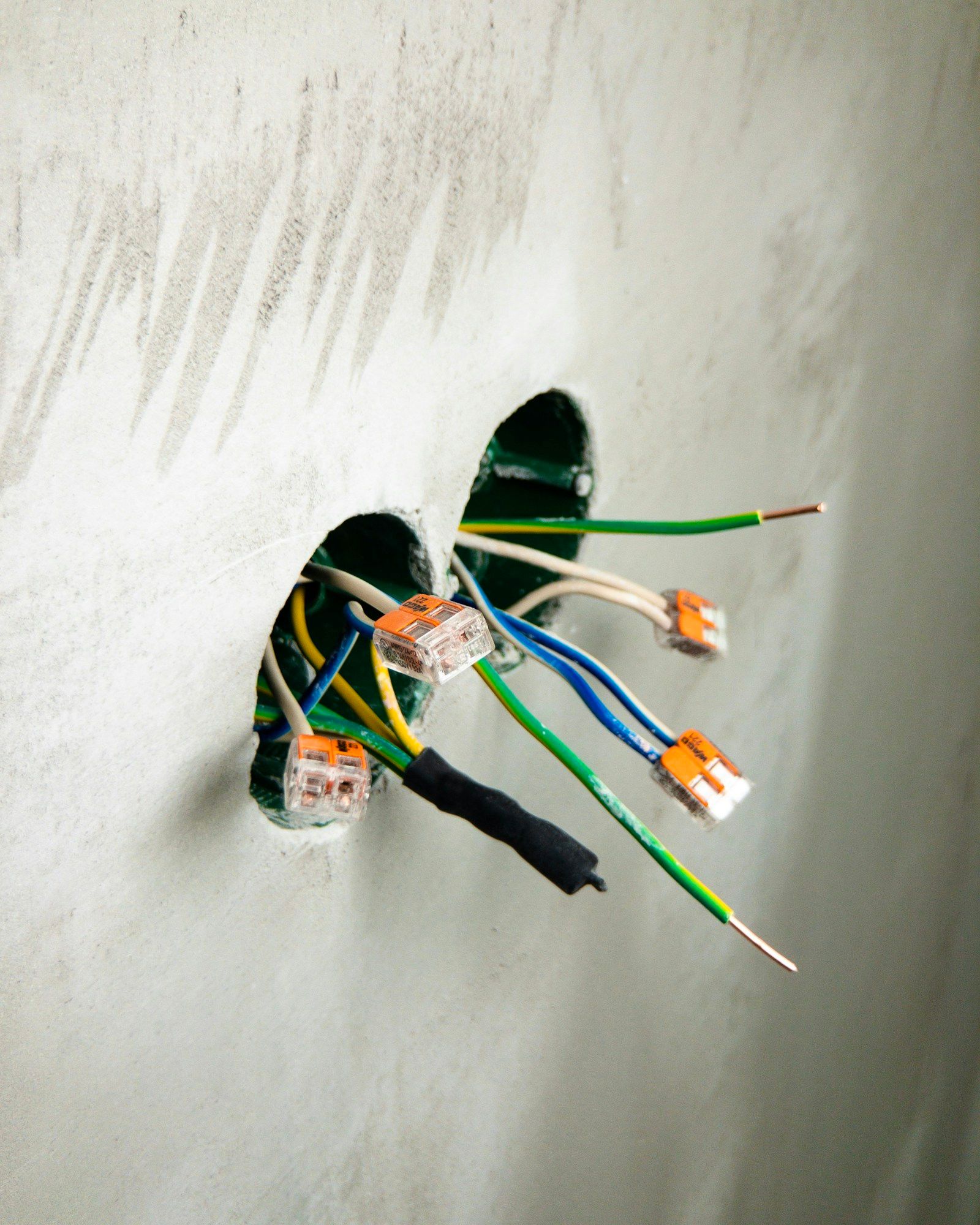 Electrical cabling and connectors inside an open party wall before boarding